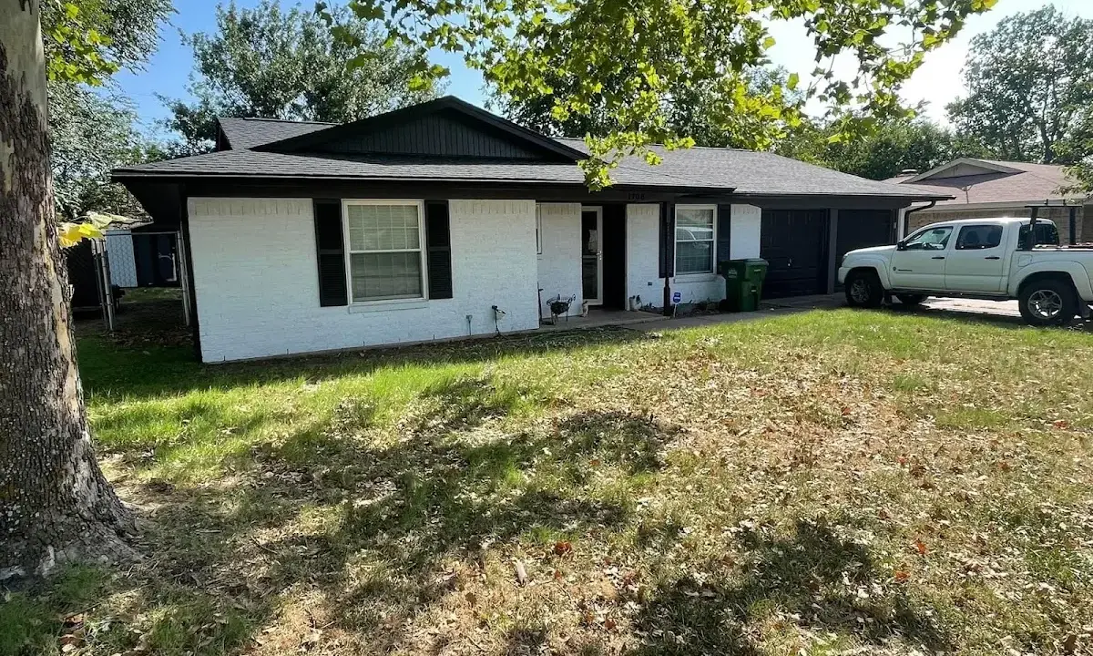 Professional roofing crew working on a residential roof in Ghent